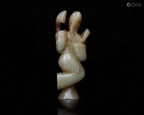 AN OLD HETIAN JADE DANCING FIGURE