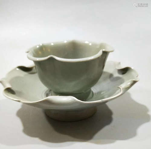 A CELADON-GLAZED TEACUP WITH HOLDER