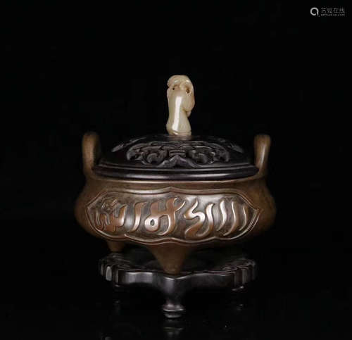 A BRONZE MOLDED TRIPOD CENSER