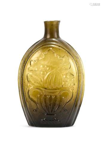 BLOWN-MOLDED GLASS FLASK In amber. Obverse with molded fruit compote decoration. Reverse with molded cornucopia decoration. Height 7