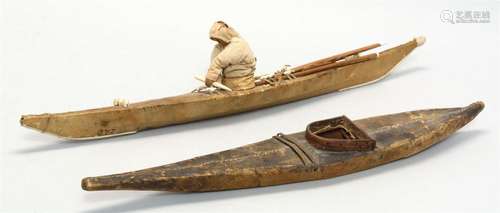 TWO SEALSKIN KAYAK MODELS One from Greenland, with a cloth figure in cockpit, and fitted with skegs fore and aft, and fore and aft d...