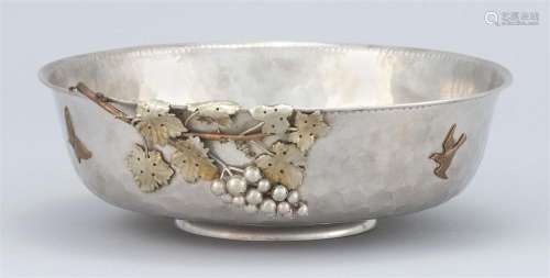 GORHAM STERLING SILVER AND MIXED METAL CENTER BOWL Low hammered sides with applied birds, butterflies, fruiting grapevine and a laur...