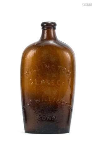 WILLINGTON BLOWN-MOLDED GLASS FLASK In amber. Obverse with molded eagle and Liberty shield decoration. Reverse with molded text 