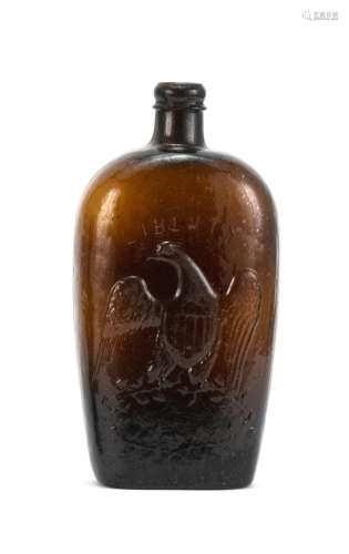 WILLINGTON BLOWN-MOLDED GLASS FLASK In brown. Obverse with molded eagle and Liberty shield decoration. Reverse with molded text 