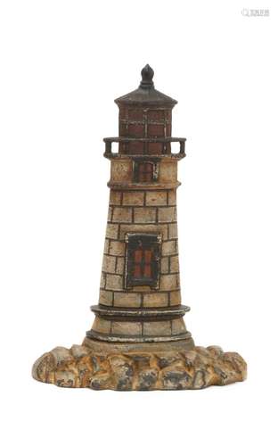 CAST IRON LIGHTHOUSE DOORSTOP Polychrome lighthouse on a rockery base. Back with molded mark 