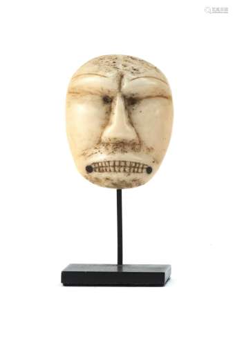ESKIMO CARVED BONE FACE Baleen dots inlaid to corners of mouth. Height 1.75