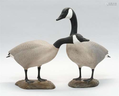 PAIR OF LLOYD HAVENS MINIATURE CANADA GEESE With carved wings and tails. Mounted on chip-carved bases. Signed on undersides in elect...