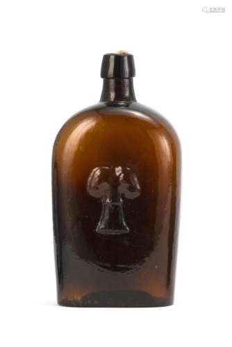 TRAVELER'S BLOWN-MOLDED GLASS FLASK In amber. Obverse with molded wheat and tool decoration. Reverse with molded text 