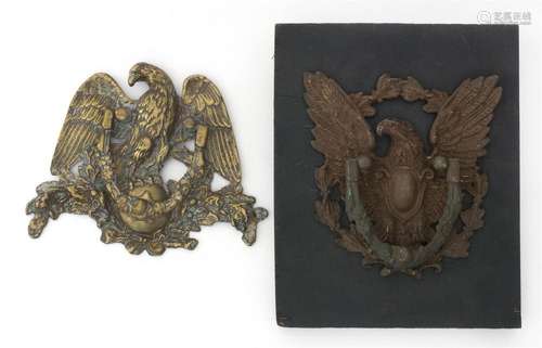 TWO BRASS EAGLE-FORM DOOR KNOCKERS One mounted to a panel. Heights 9