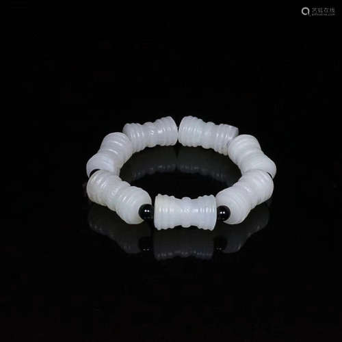 AN OLD HETIAN JADE TUBE BRACELET