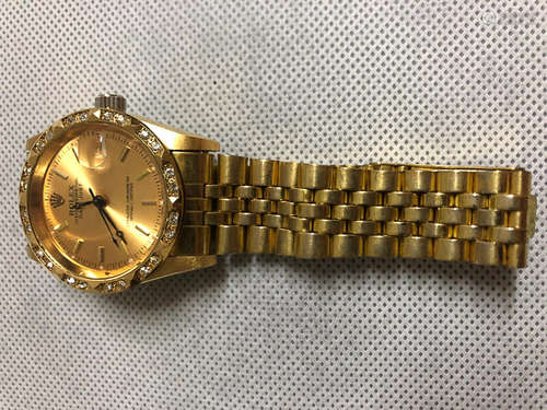 A ROLEX GOLD WATCH