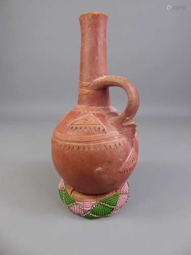 An Antique Carved Terracotta Jug