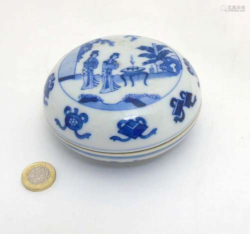 A Chinese blue and white circular ink pot and cover, decorated with female