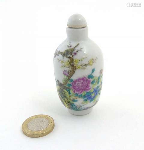 An Oriental Famille Rose snuff bottle depicting singing birds perched on ch