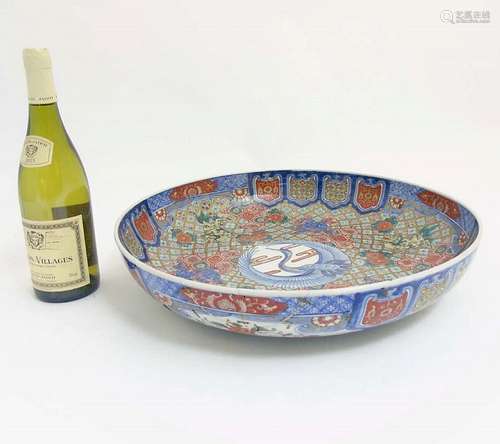 A Large Chinese bowl decorated in Imari style colours on a white ground, de