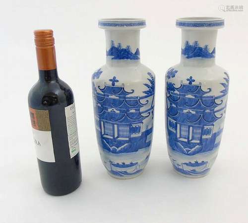 A pair of Chinese blue and white Rouleau vases, depicting a Chinese temple