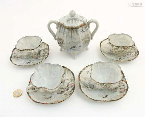 A Japanese part tea set, comprising a two handled sugar bowl and cover, and