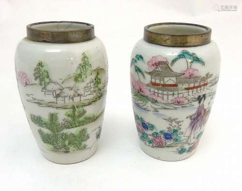 A pair of Chinese famille rose vases with silver rim, depicting oriental wo