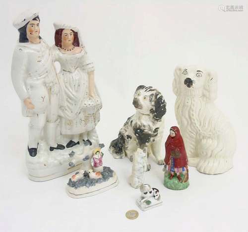 A quantity of Staffordshire items comprising a Scottish couple, a figure an