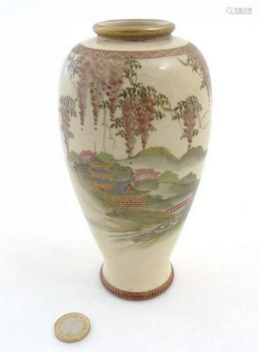 A Japanese Satsuma vase depicting a pagoda garden scene with wisteria decor