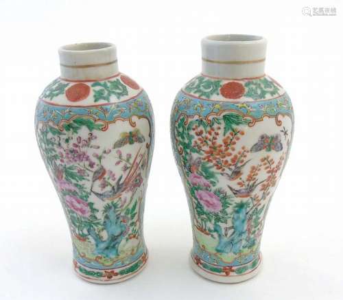 A pair of Chinese Cantonese baluster vases, having panels depicting song bi