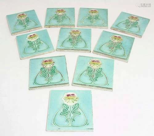 Ten c1907 Art Nouveau embossed flower tiles, decorated in a green glaze, re