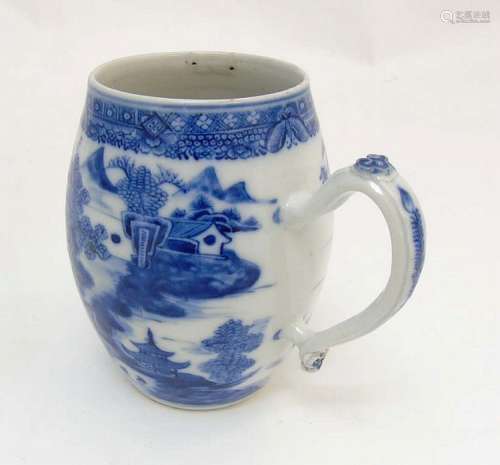 An 18thC Chinese blue and white export tankard, depicting a continuous rive