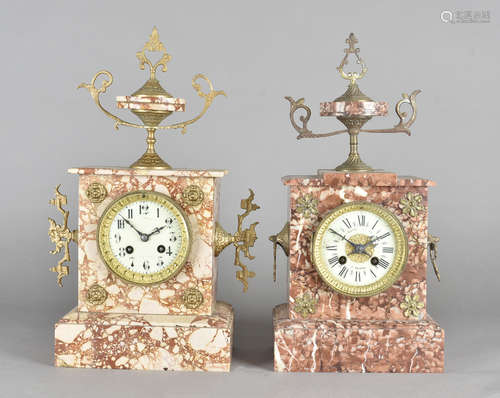 A variegated marble mantel clock, with arabic numerals, drum movement, surmounted with twin