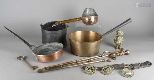 A quantity of metalware, including comical money box, various horse brasses, crane candlestick,