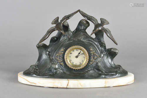 An art deco bronzed spelter clock, the surround decorated as a stormy sea with seagulls aloft on