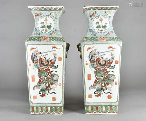 A large pair of Chinese four sided tapered vases, decorated with warrior figures fighting bats on