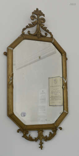 A 19th Century elongated octagonal bevelled glass and gesso framed wall mirror, 76 cm x 35 cm (af)