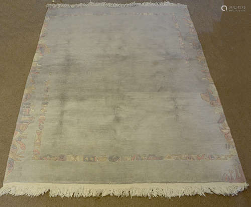 A modern Nepalese wool carpet, with light blue ground and stylised bordered design, 125 cm x 175 cm