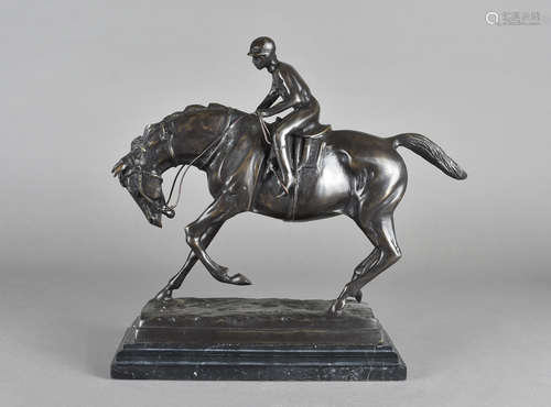 A modern reproduction bronze casting of horse and Jockey, after P J Mene on a black marble base,