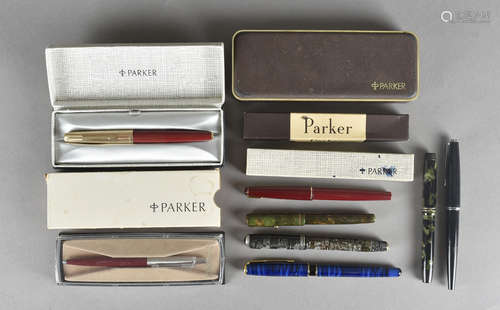 A collection of Parker fountain pens, and boxes, including a Parker 51 with burgundy body and gold