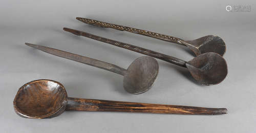 A collection of four large tribal spoons, including a Polynesian example with cross hatched design