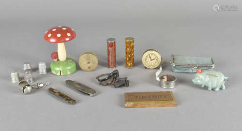 A collection of sewing related items, including novelty tape measures, a toad-stool darning tool and