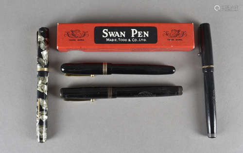A small group of Swan fountain pens, three with black bodies, another marbled all with gold nibs