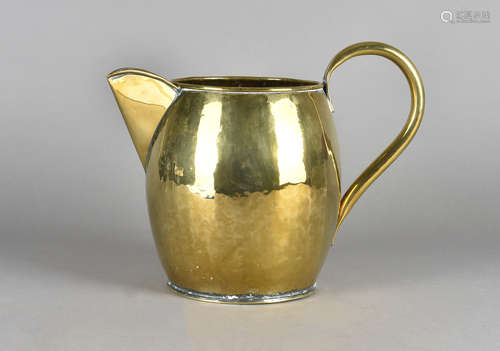 An 18th Century brass large jug, of ovoid form with planished body, high strap handle and cut spout,