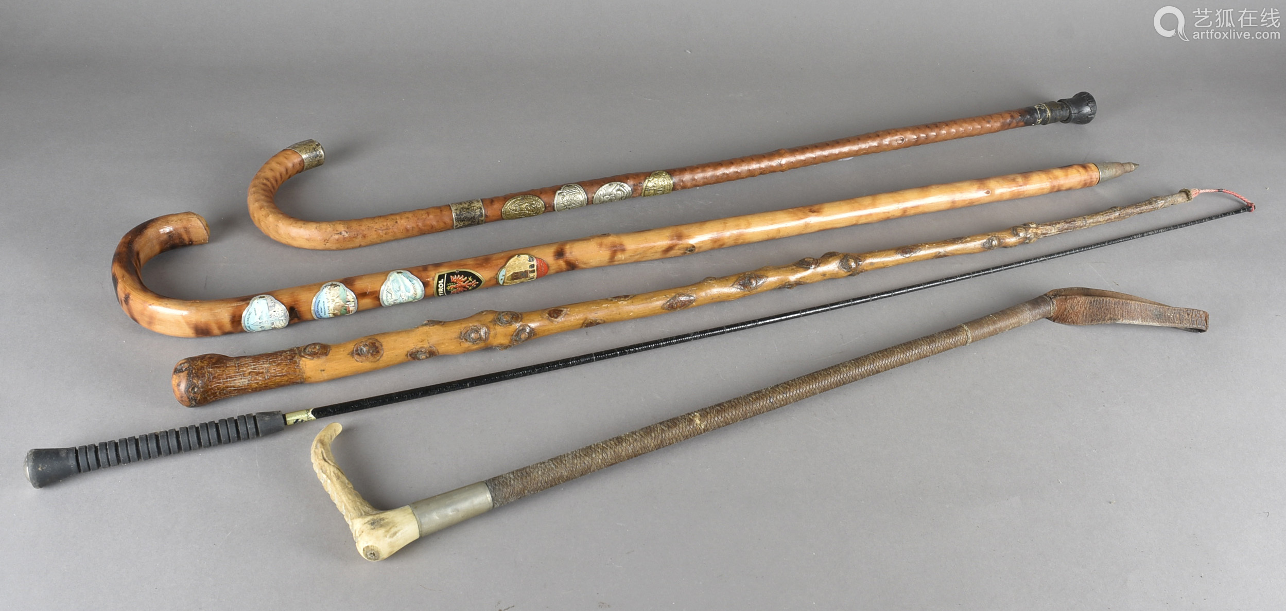 Three alpine walking sticks, with applied badges together with an ...