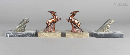 Two pairs of French art deco garniture ends, modelled as leaping gazelles, and stylised scrolls