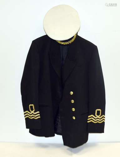 A Commander's Naval Uniform, together with three Royal Naval White Ensign flags, various peak caps