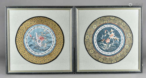 A pair of Chinese silk embroidered floral rank badges, of circular design centred with floral