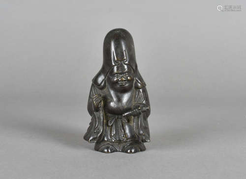 An 18th Century Chinese bronze figure, modelled as an elder clutching scroll, with elongated head in