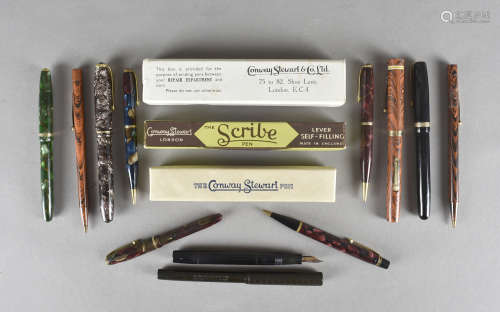 A small collection of Waterman and Conway Stewart fountain pens and pencils, including a red and