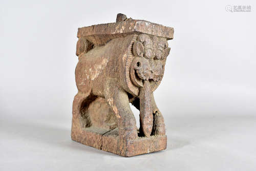 An early Indo Chinese carved temple dog, modelled with a protruding tongue in carved hardwood,