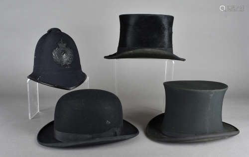 A collection of hats, including a Somerset Constabulary policeman's helmet, a Dunn & Co bowler, a