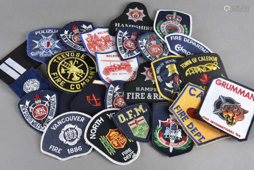A large collection of Fire Brigade cloth badges and buttons, including Hampshire, Cornwall, Avon,