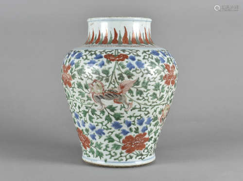 An Chinese porcelain Wucai vase, of baluster shape, decorated with Buddhistic lion dogs, against a