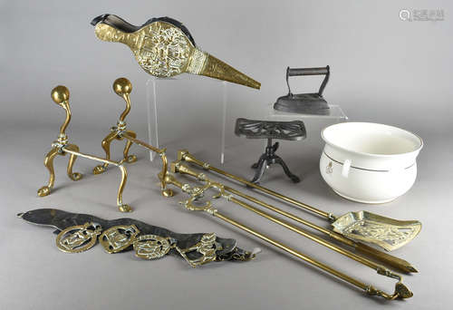 A set of brass fire irons, a brass embossed pair of bellows, fire dogs, trivet etc